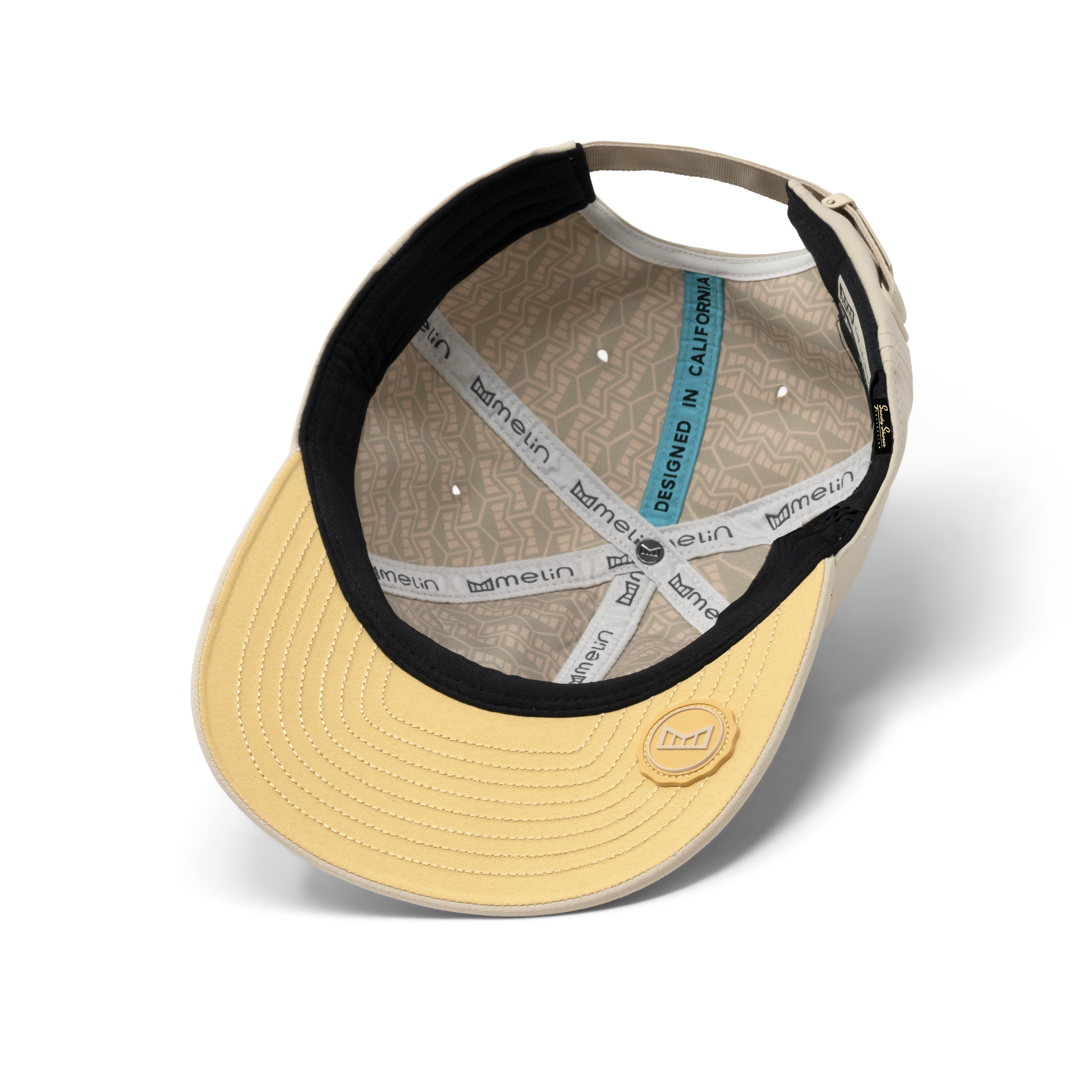 The inside view of the melin The Legend Hydro Performance Dad Hat in Sandshell